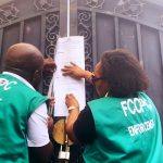 Officials of the FCCPC seal up a Chinese supermarket in Abuja